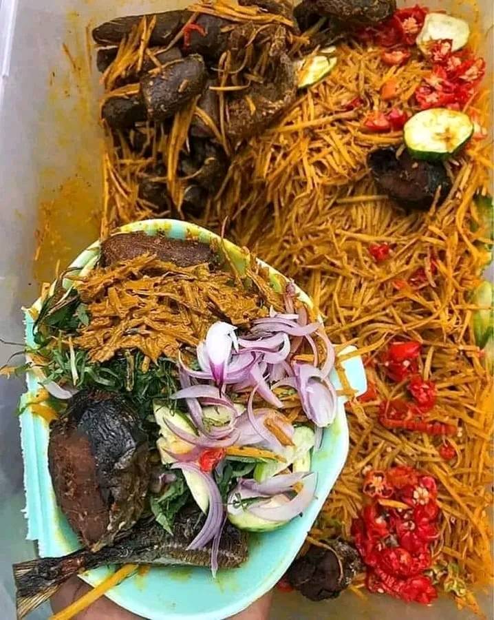 abacha garnished with fried meat, pepper, fish , onions and many ingredients